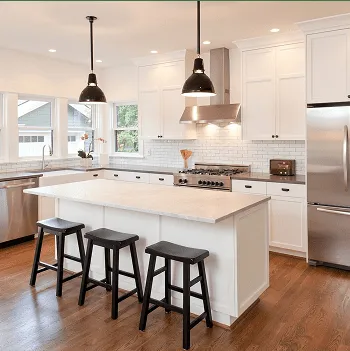 White kitchen with a large island and black pendants