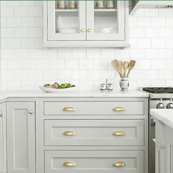Sage green shaker cabinets with gold pulls