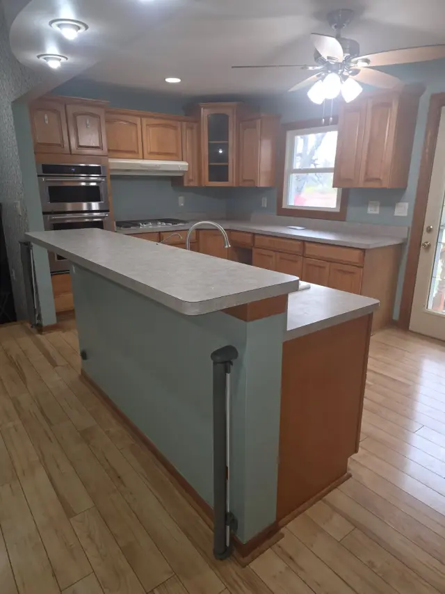 Before: honey oak peninsula kitchen