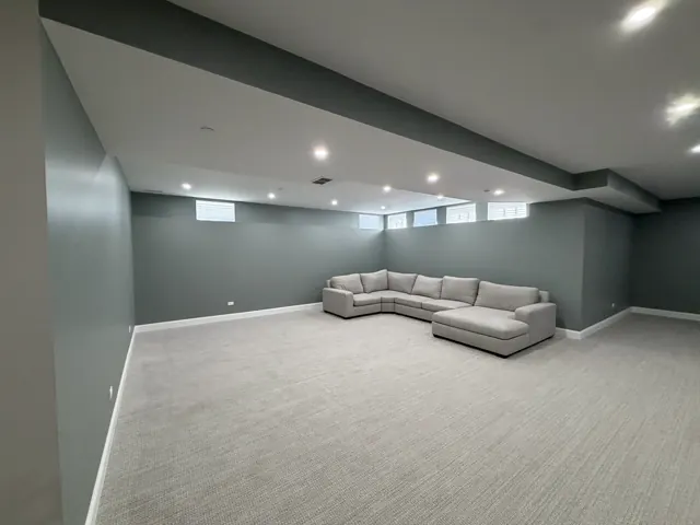 SRC finished basement family room with new carpet and recessed lights